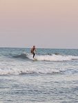 surfer in pink sunset
